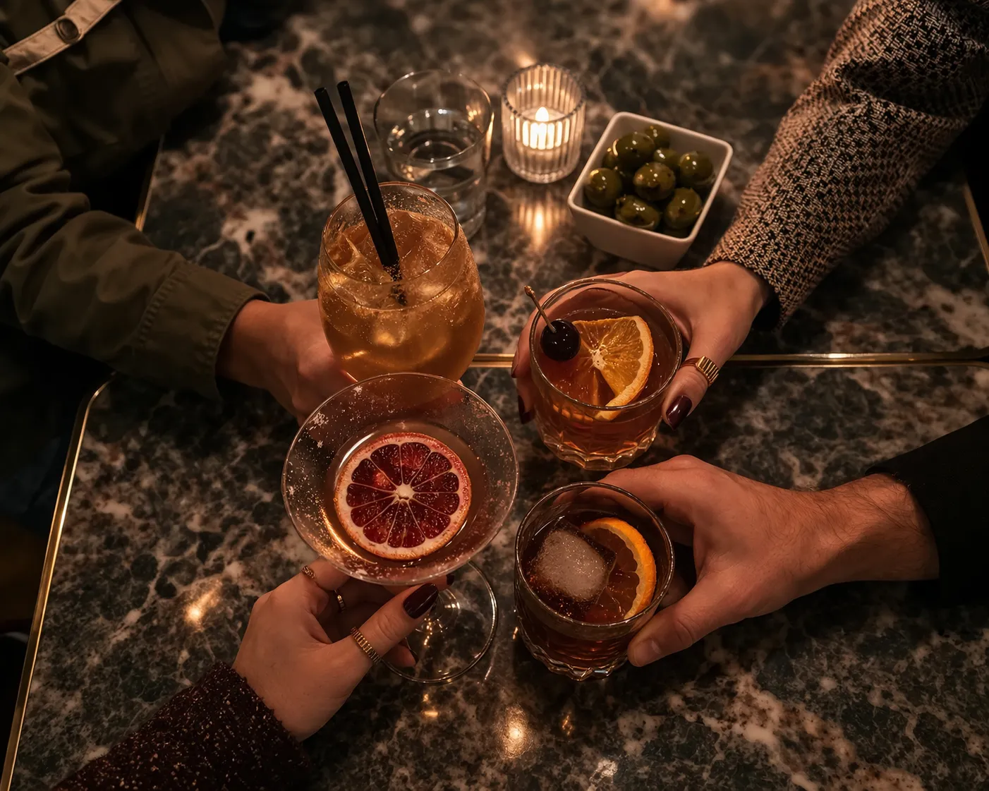 Cocktails raised over a marble table in the Gold Room.