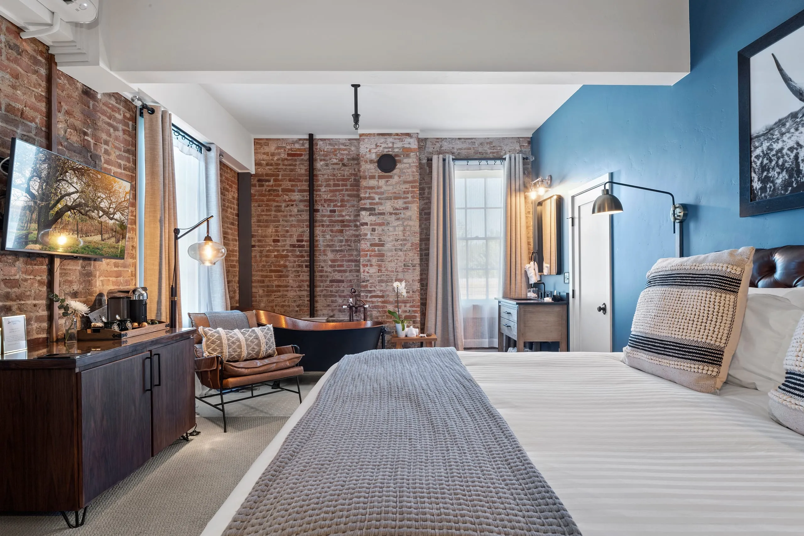 Room #1 at the Jacksonville Inn: Soak in a copper clawfoot tub beneath original brick.