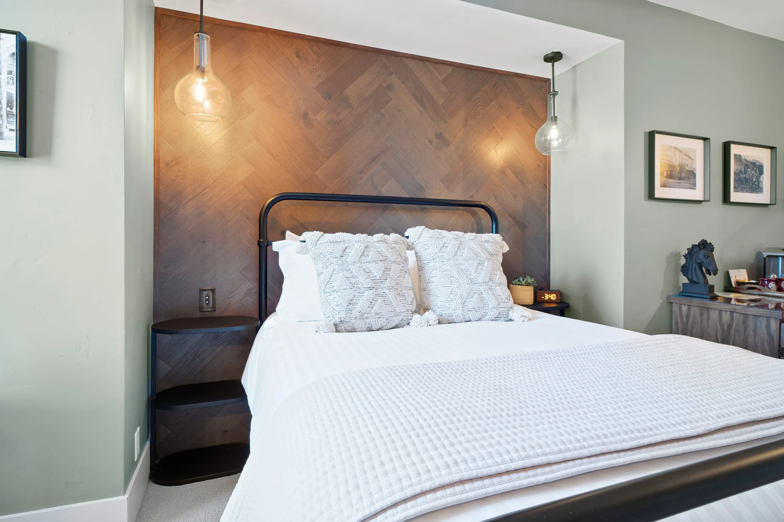 Room #3 at the Jacksonville Inn: A herringbone wall frames the bed, and a reading chair looks out over the hills.