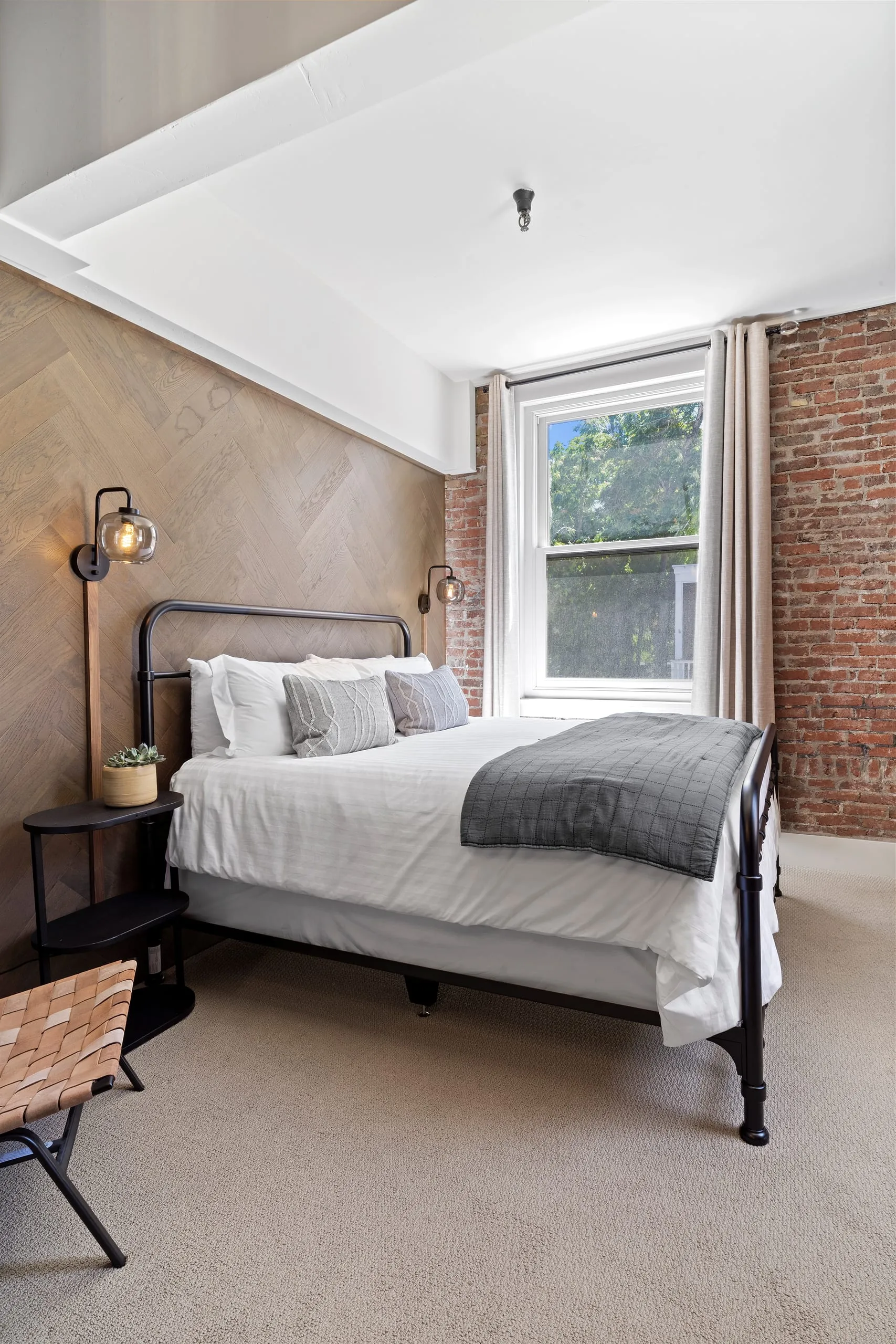 Room #5 at the Jacksonville Inn: Tall windows look out into the treetops over original brick.