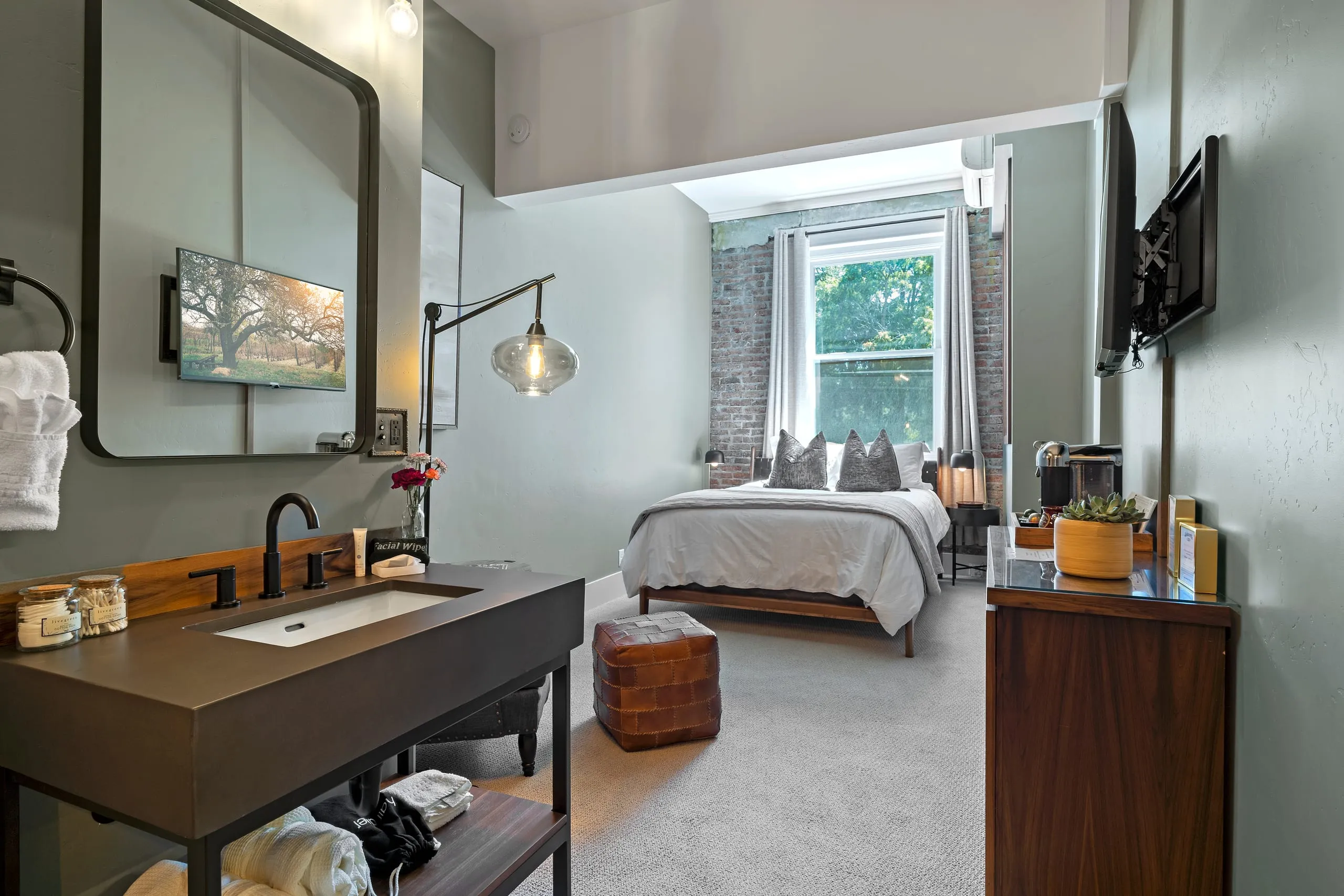 Room #7 at the Jacksonville Inn: A snug hideaway with a woven headboard, exposed brick and a window onto the trees.